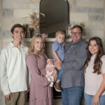 family mom dad three children and newborn baby girl lifestyle photograph