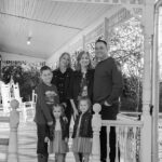 family with four young kids black and white photograph